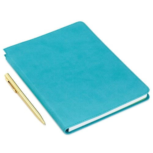 Cuaderno turquesa y bolígrafo de metal